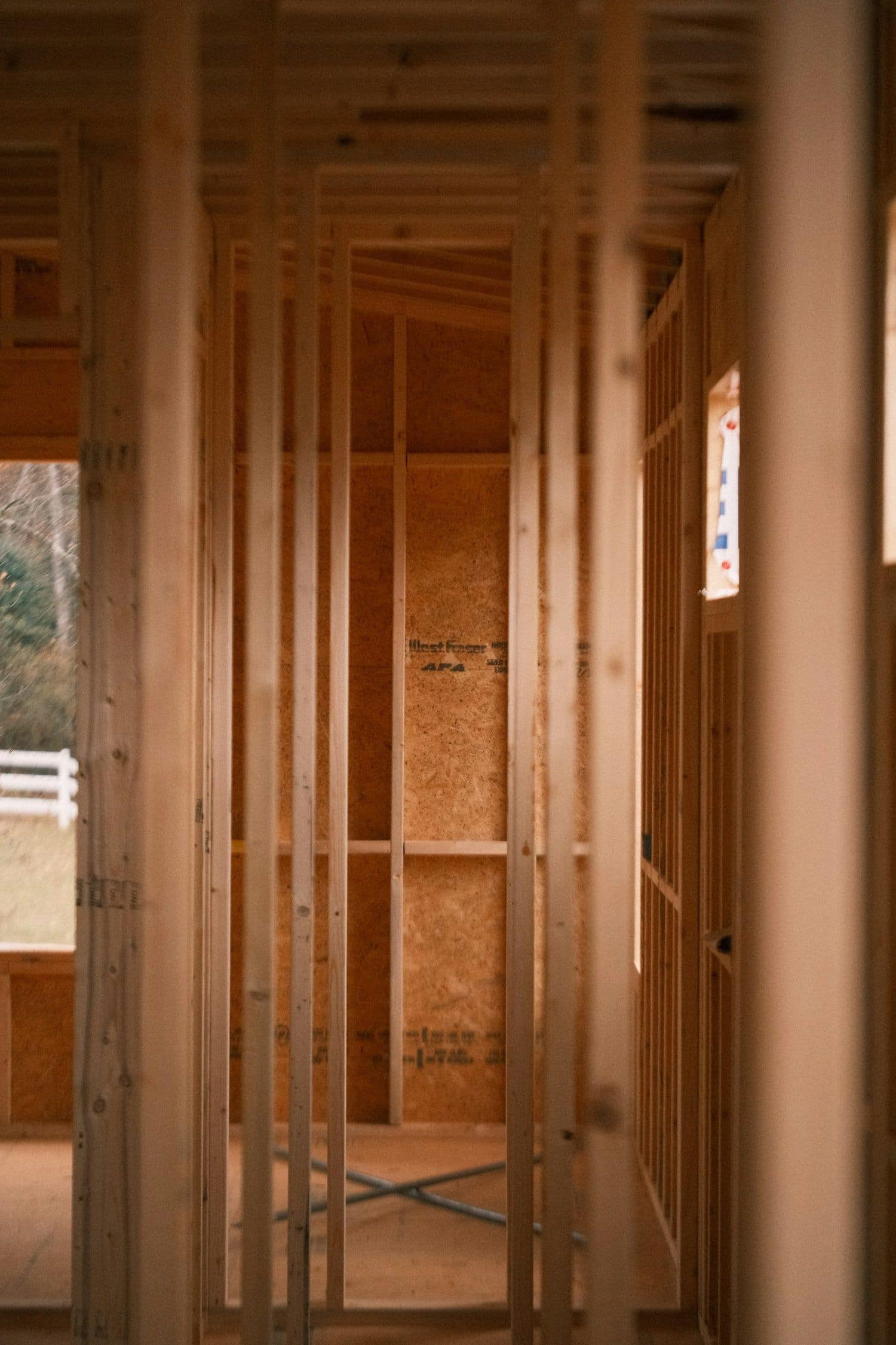 Custom home interior under construction with wood framing