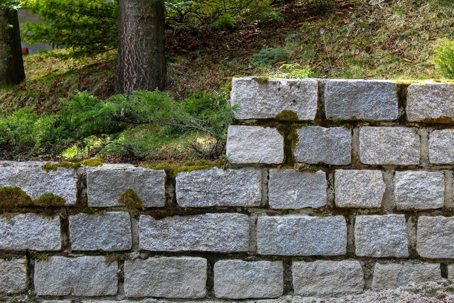 Engineered stone retaining wall under construction